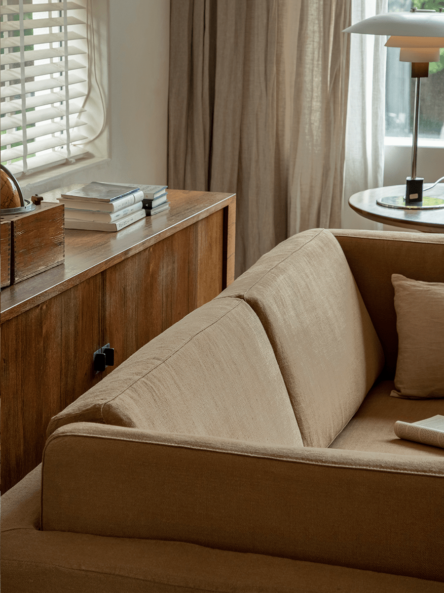 Beige Skirt Linen Sofa in a modern living room, linen fabric and wooden furniture, create a peaceful atmosphere