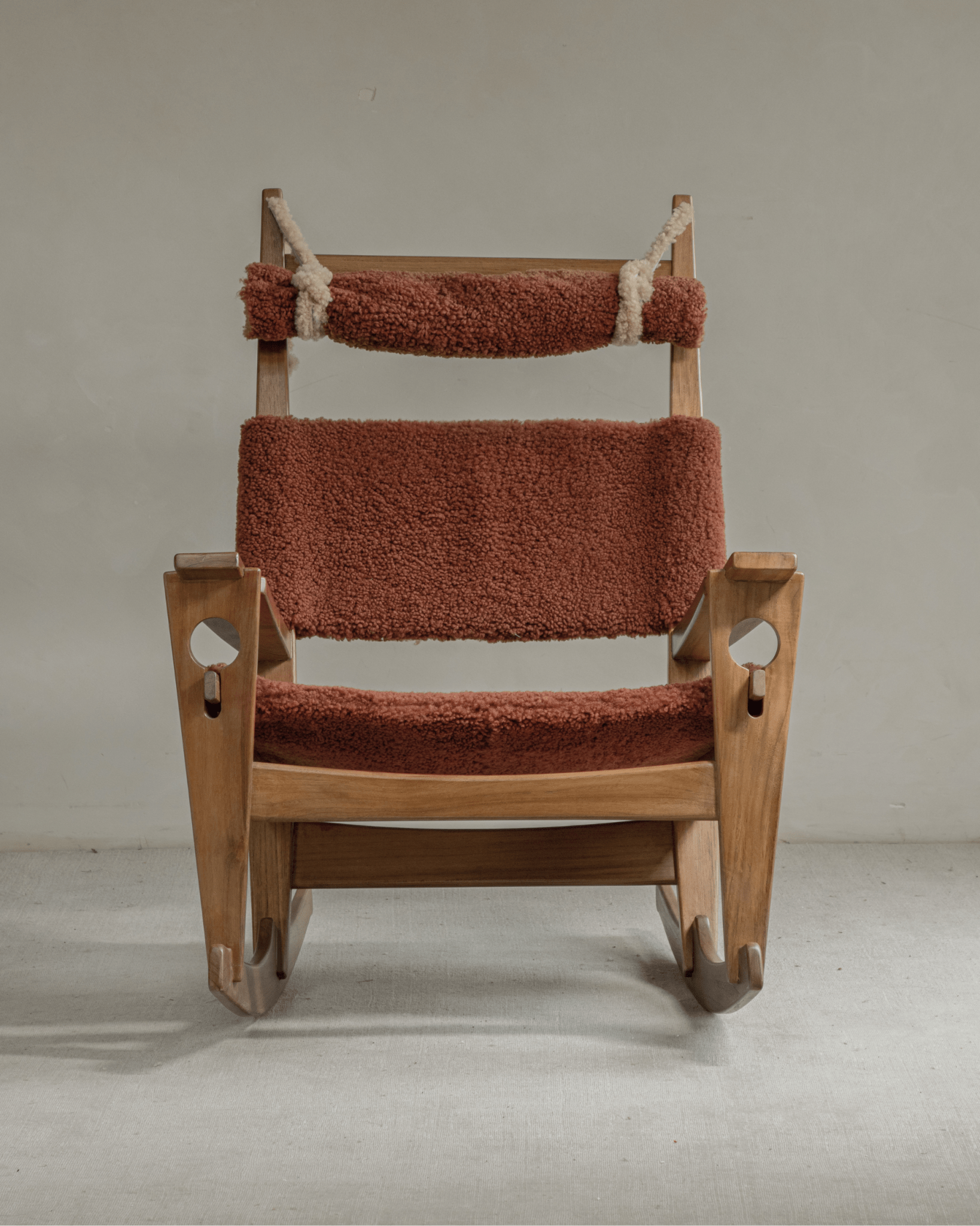 Hans Rocking Chair: Teak frame, plush terracotta shearling upholstery, Danish design.