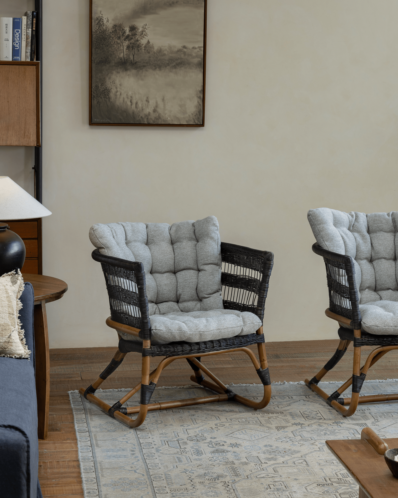 Helian Rattan Chair, gray cushion, black and natural rattan frame, cozy interior design, stylish.