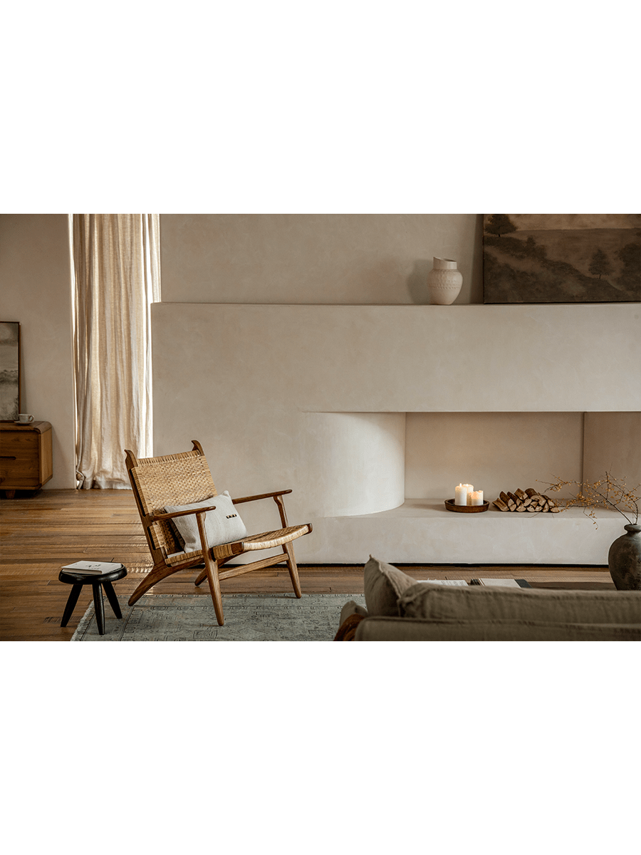 Horn Lounge Chair in interior setting, oak frame, natural rattan seat, ergonomic design, enhancing interior decor