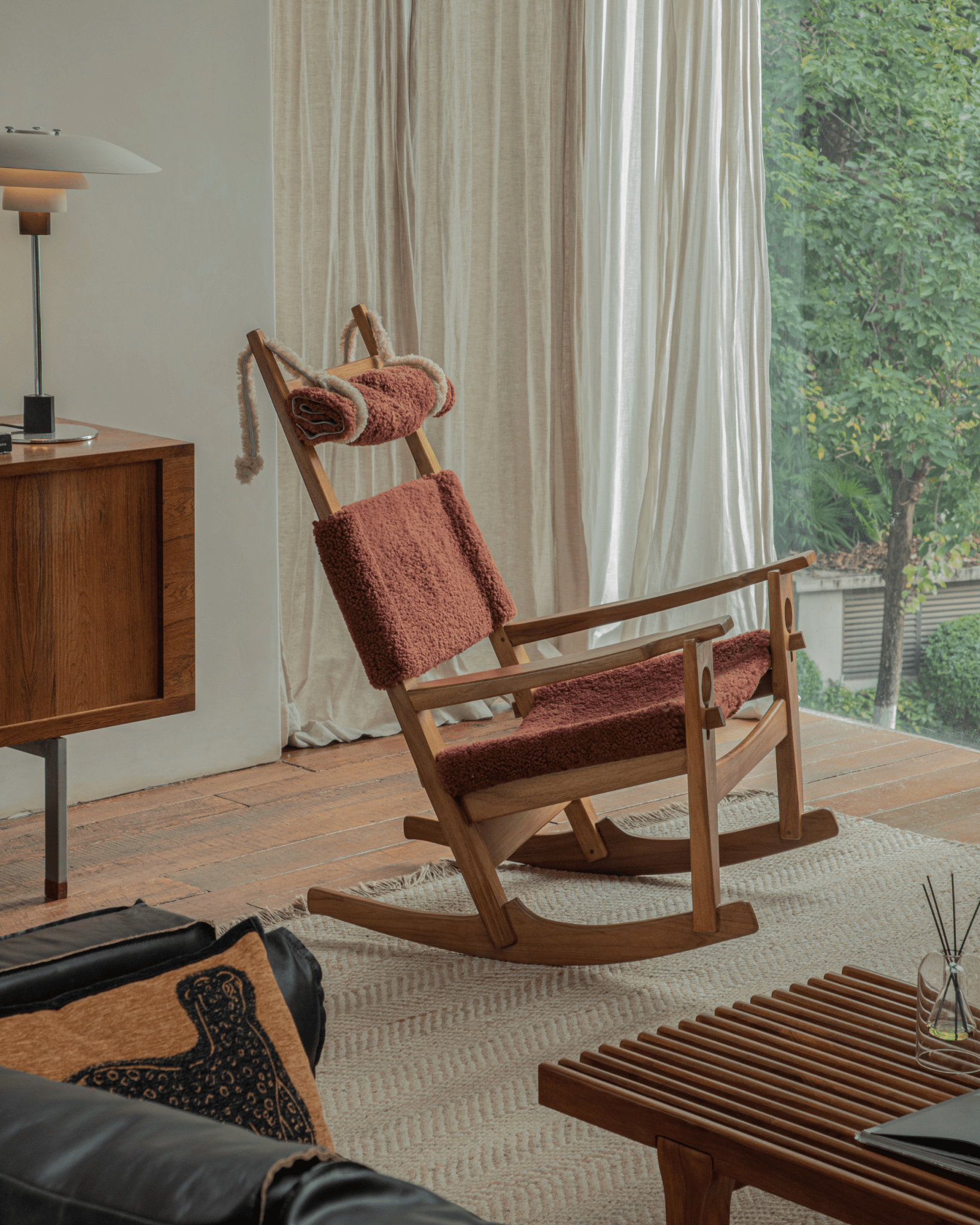 Hans Rocking Chair in Burgundy Shearling, Danish design with teak frame, Cozy interior setting