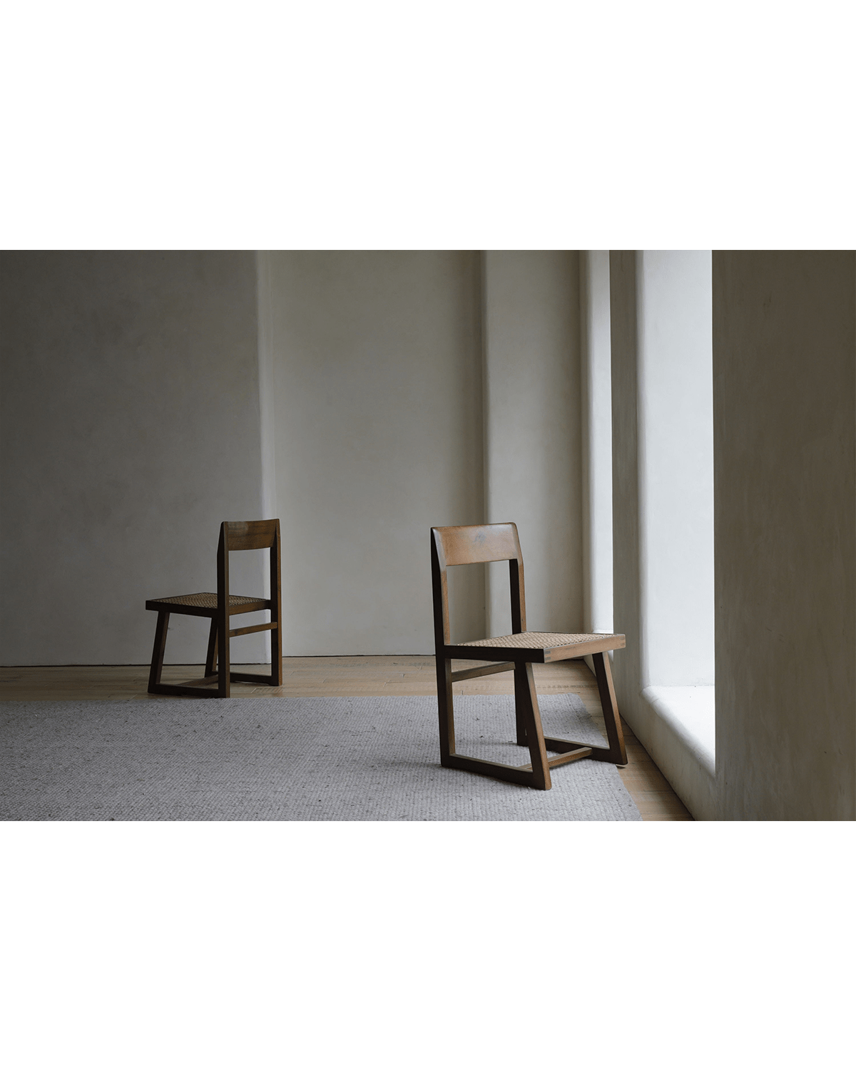 Chandigarh Box Chair, mid-century modern design with woven seat and wooden frame in interior setting