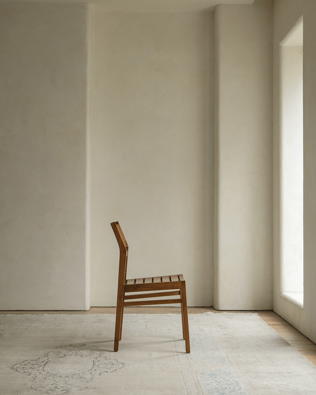 Beam Chair - Teak wood chair in a minimalist setting, showcasing design, comfort and style.