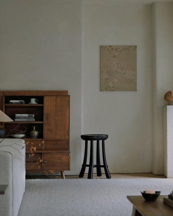 Black wooden Basin Side Table in a modern living room setting, minimalist design