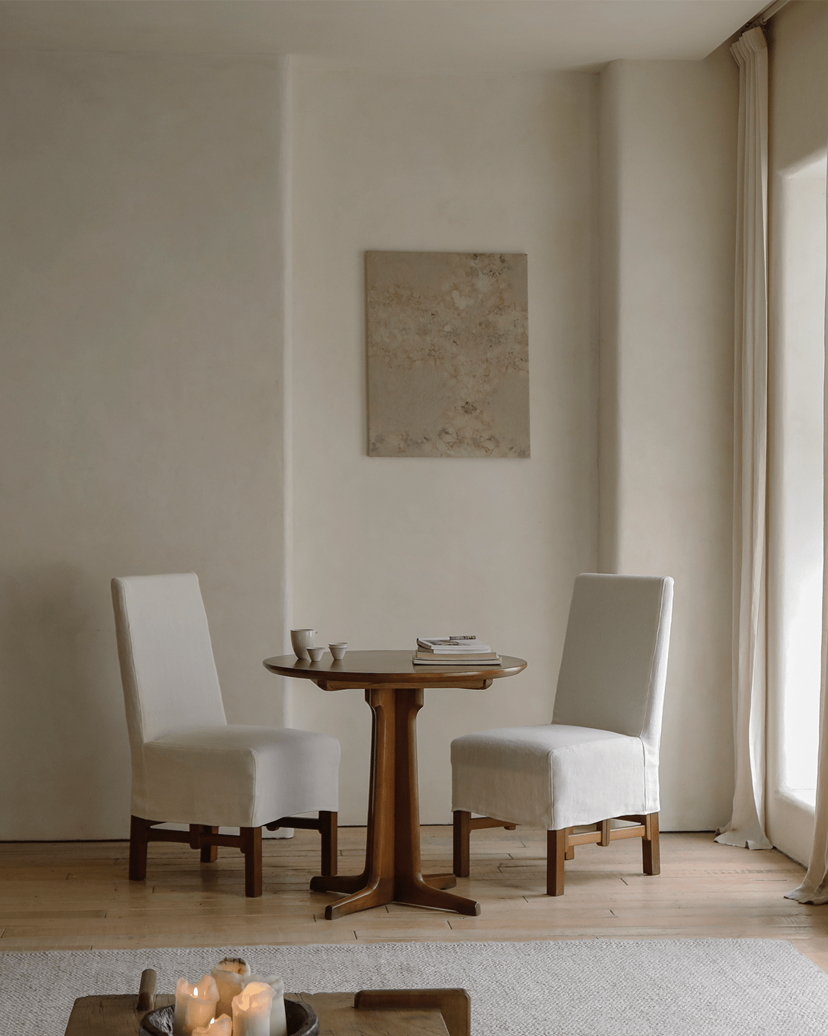 Feast Dining Chairs with white linen slipcovers in a modern dining setting