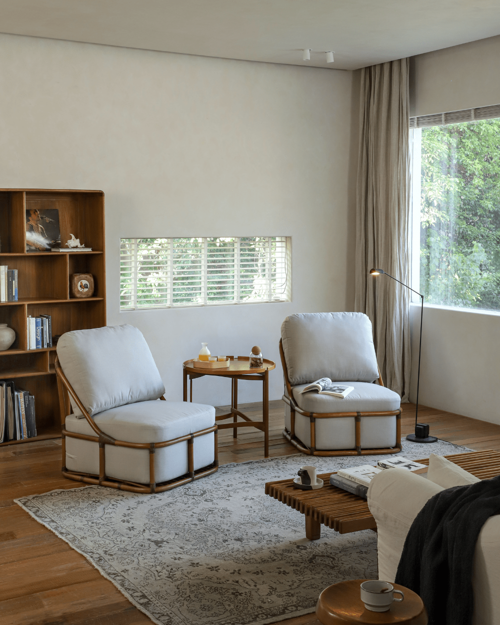 Tofu Lounge Sofa in a living room setting. Light gray cushions on rattan frame chairs, promoting comfortable seating.