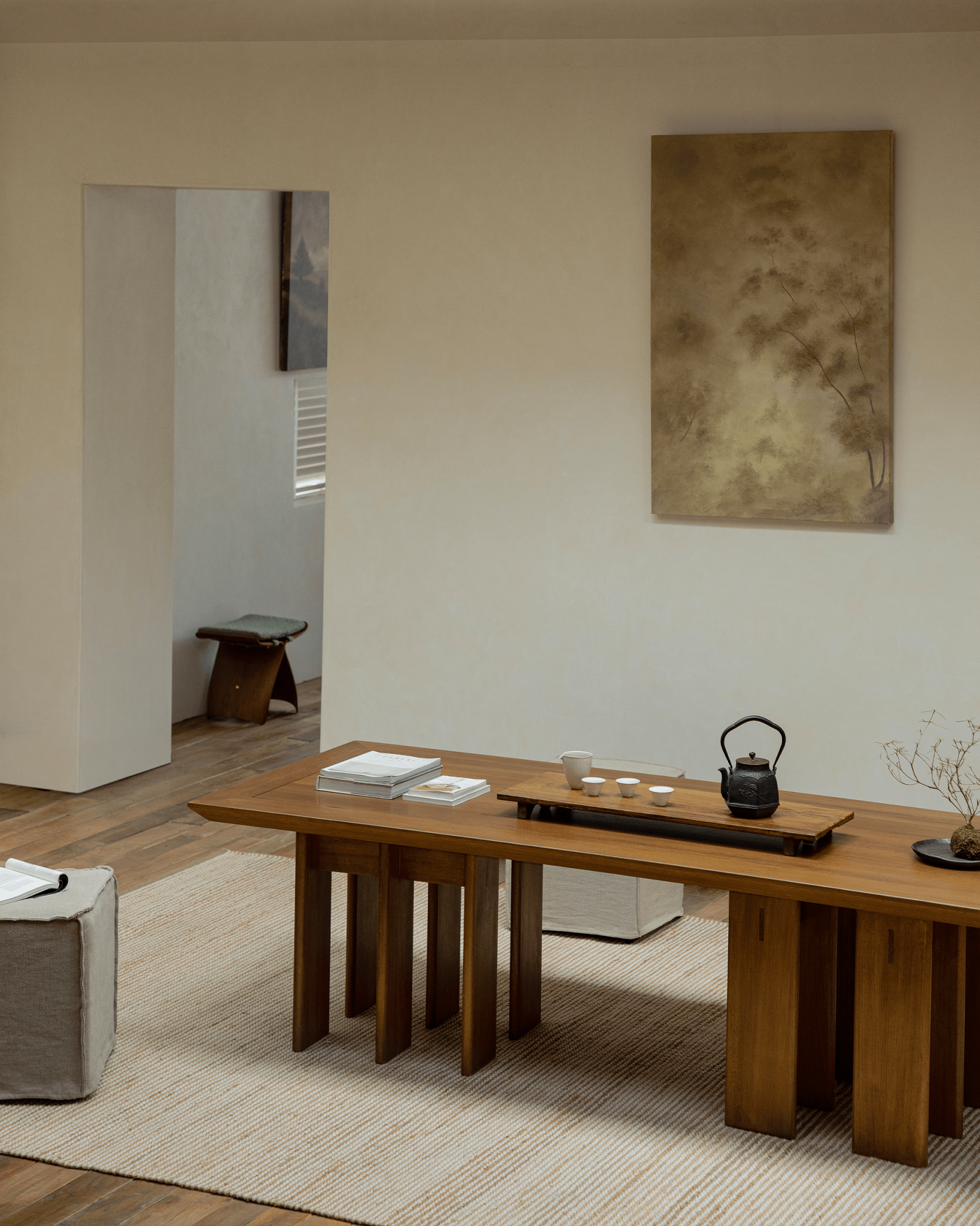Titan Teak Dining Table in a modern setting with tea set, multi-leg design, teak wood and natural light