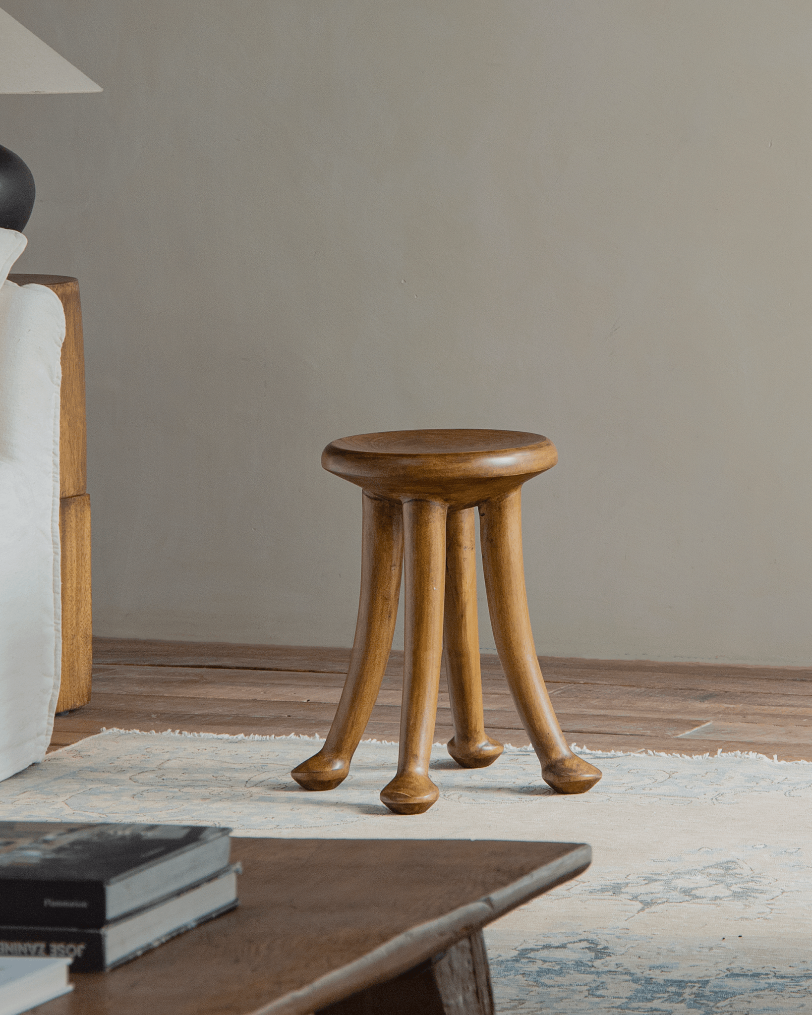 Sploot Stool made from Samanea saman wood with three legs, natural finish, for modern interiors.