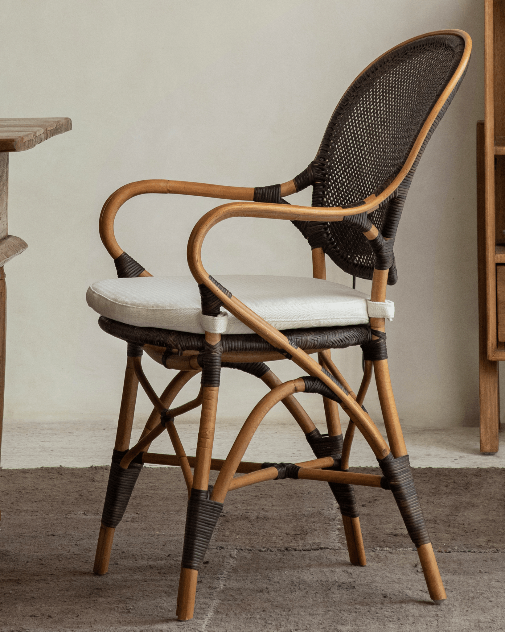 Areca Rattan Chair with handwoven rattan back and armrests, natural design, white cushion