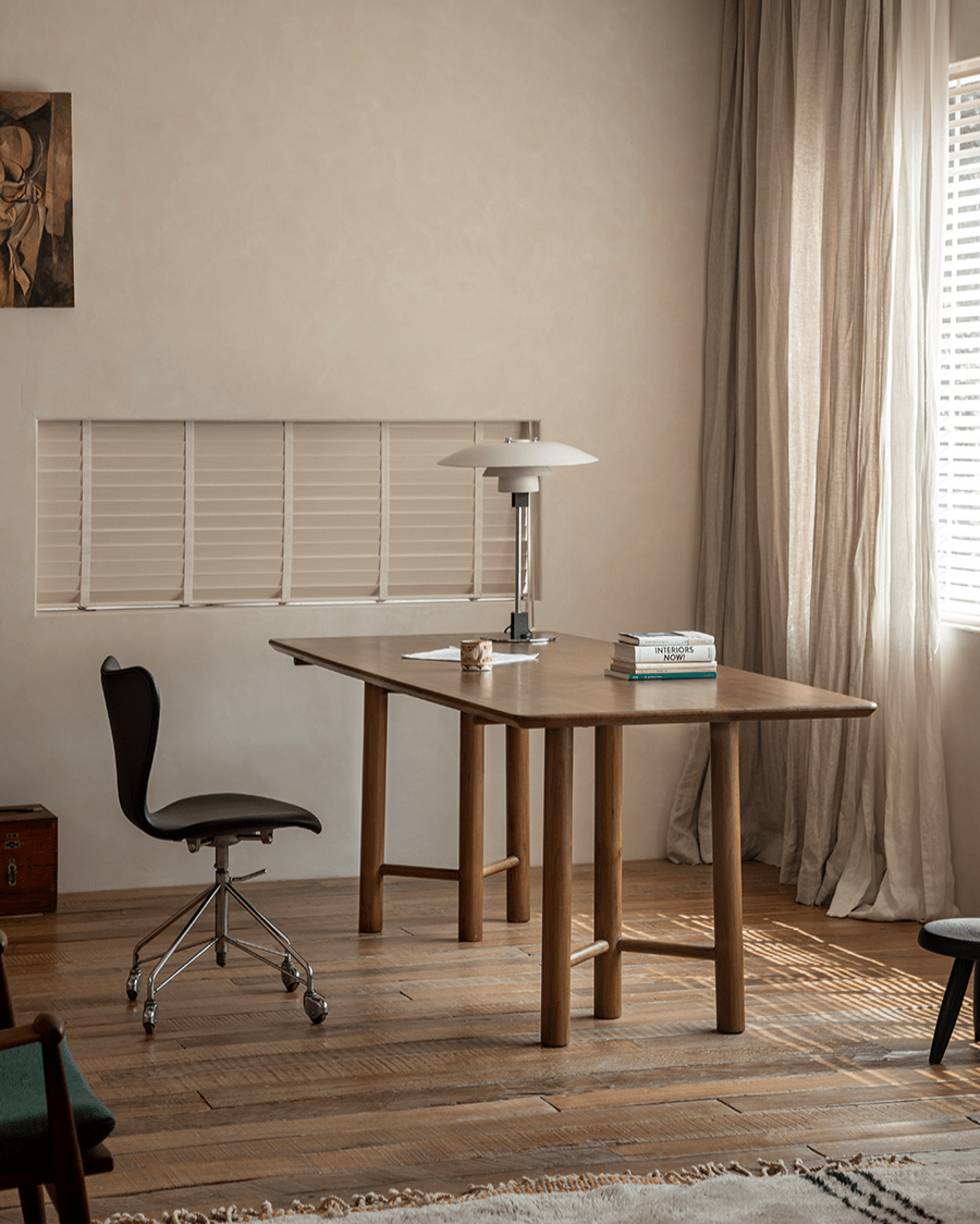 Columna Cherry Wood Table with modern design, showcasing cherry wood details, a black chair, and decor for office or dining.