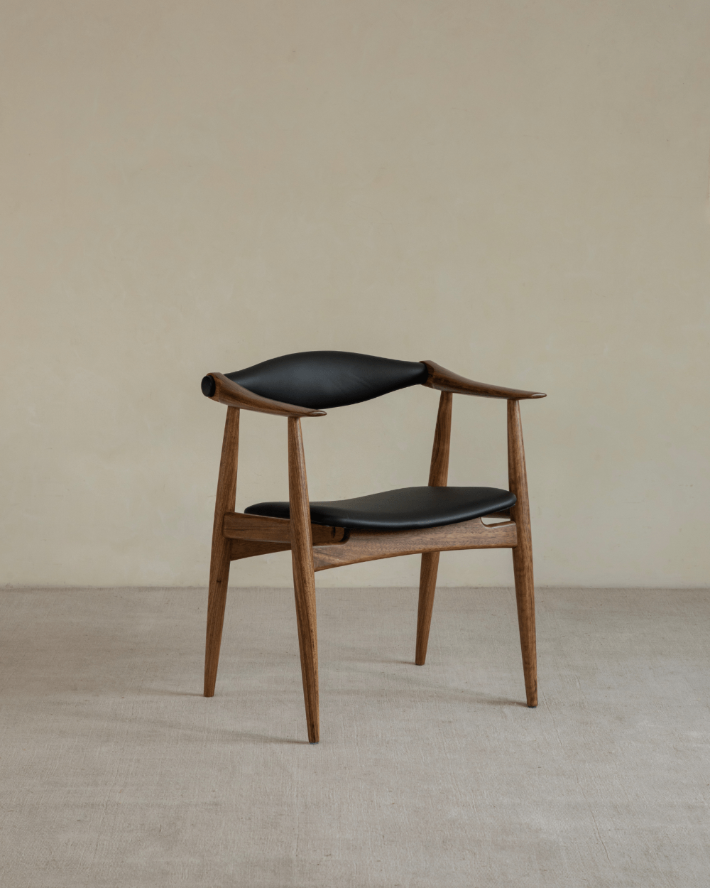 CH34 Yoke Chair in Ebony Wood with black leather upholstery, mid-century modern design.