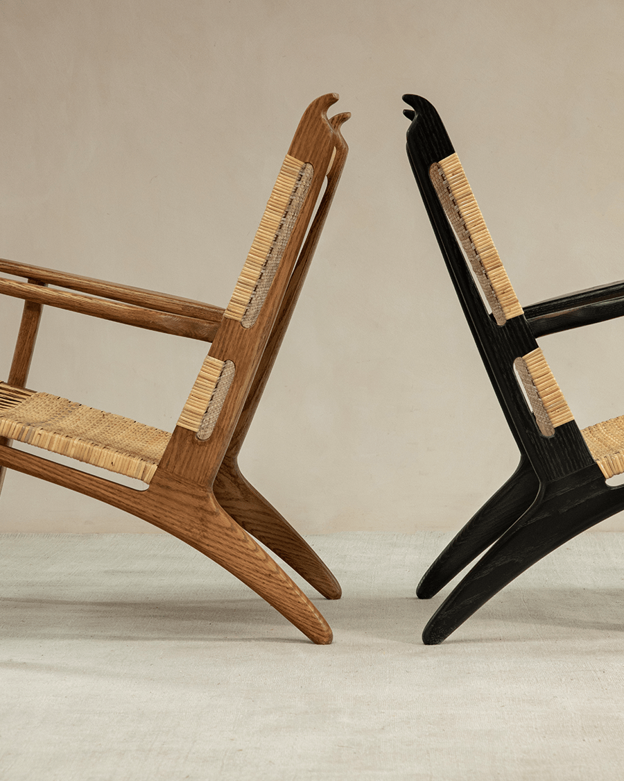 Horn Lounge Chair in wood and black, featuring oak frame, natural rattan seat, ergonomic design.