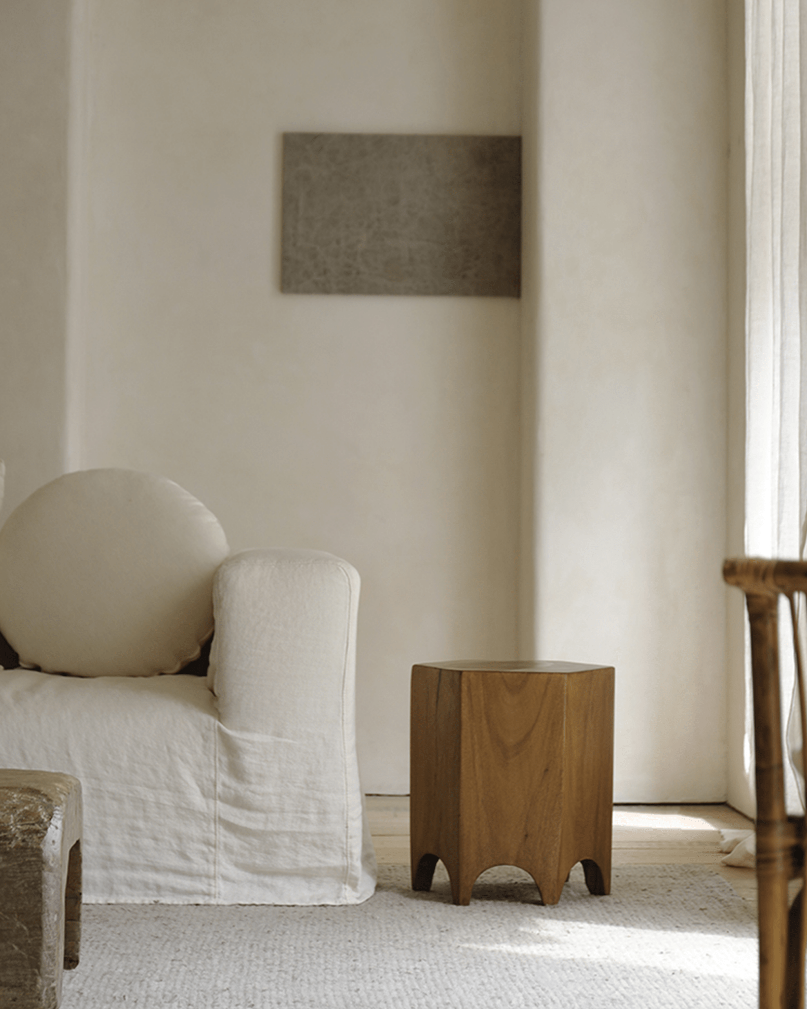 Hexagon Side Table in natural wood next to a cream-colored sofa, accent piece for modern interior
