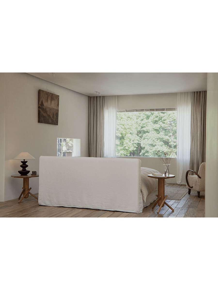 Freya Linen Bed in a serene bedroom setting, natural linen upholstery and wooden furniture