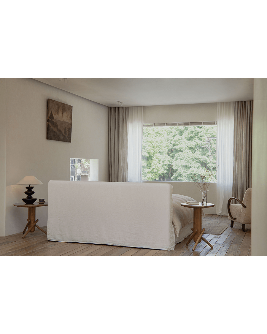 Freya Linen Bed in a serene bedroom setting, natural linen upholstery and wooden furniture