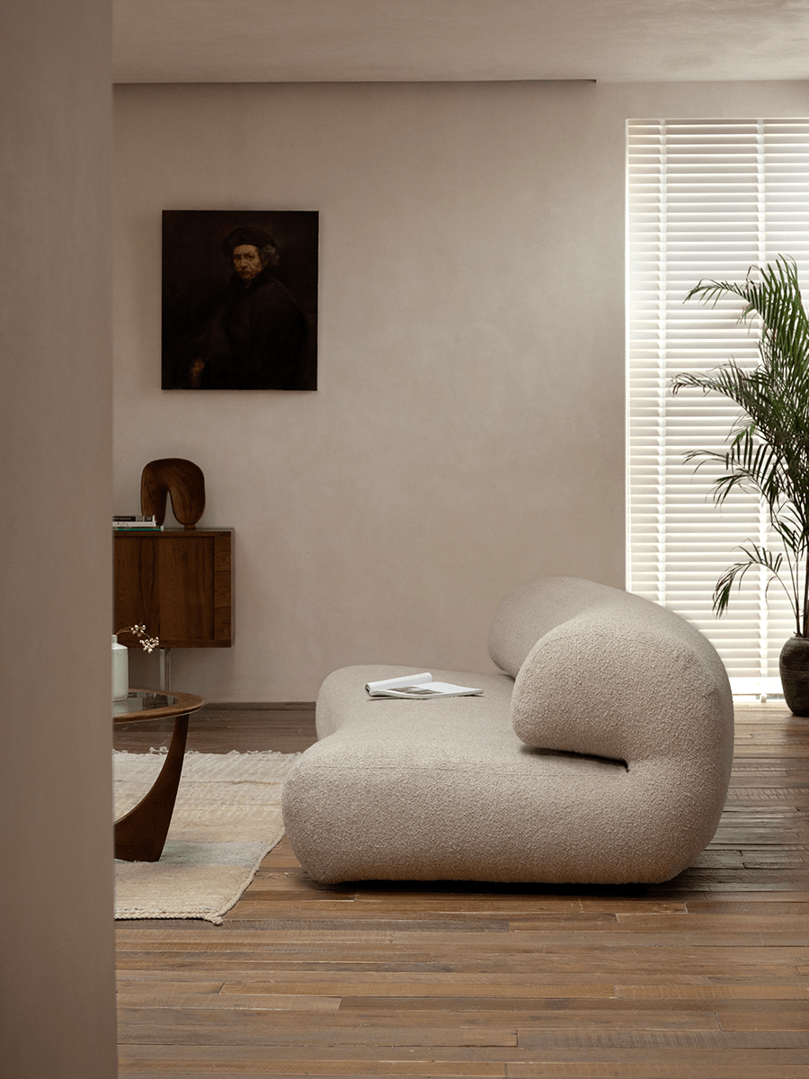 Wave Bouclé Sofa in beige bouclé fabric, stylish living room with wooden floor, retro and minimalist.