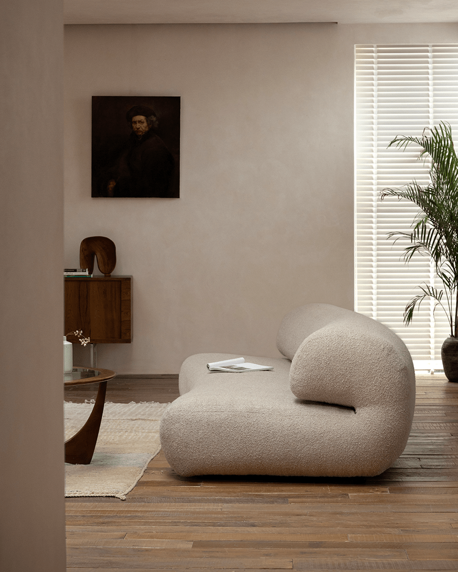 Wave Bouclé Sofa in beige bouclé fabric, stylish living room with wooden floor, retro and minimalist.