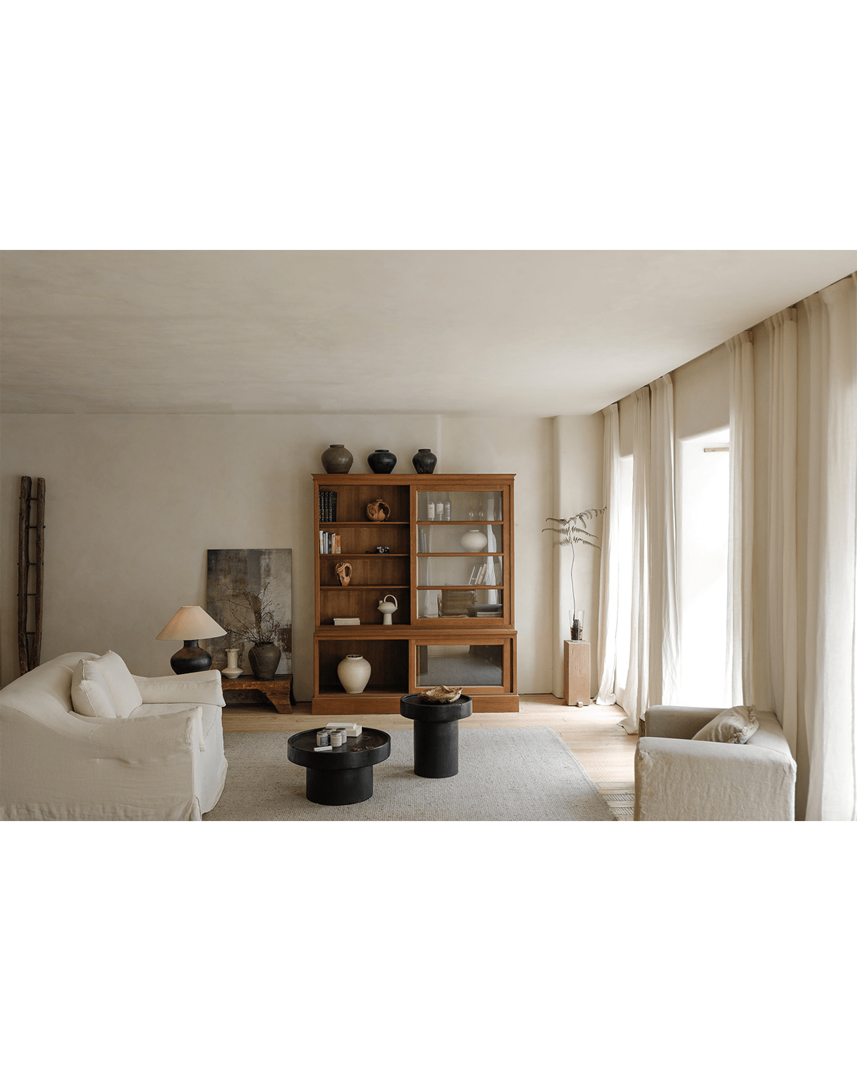 Stamp Coffee Table in carbonized black finish, modern living room decor, sculptural design with complementary furniture