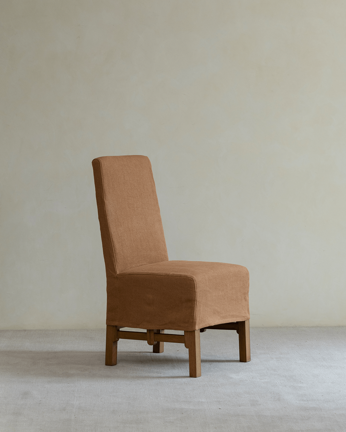 Feast Dining Chair, brown linen slipcover, wood frame, ideal for modern dining settings.
