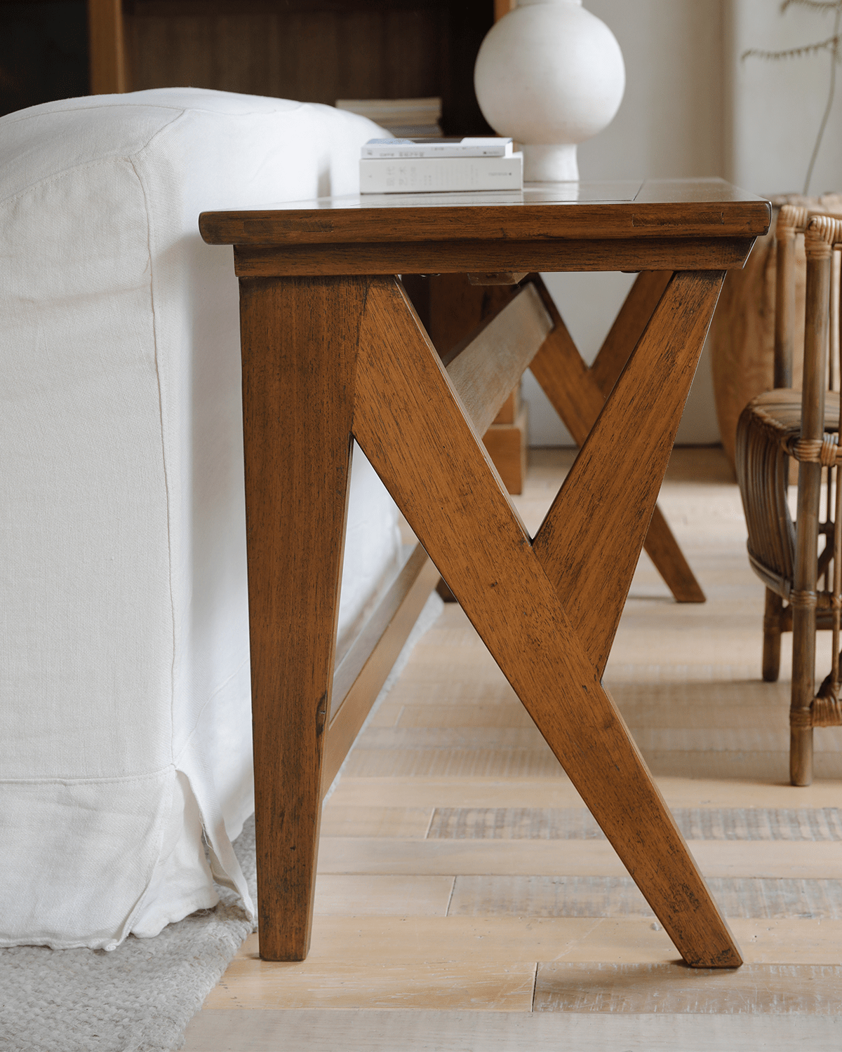 Teak writing desk, showcasing wood grain and V-shaped leg design.