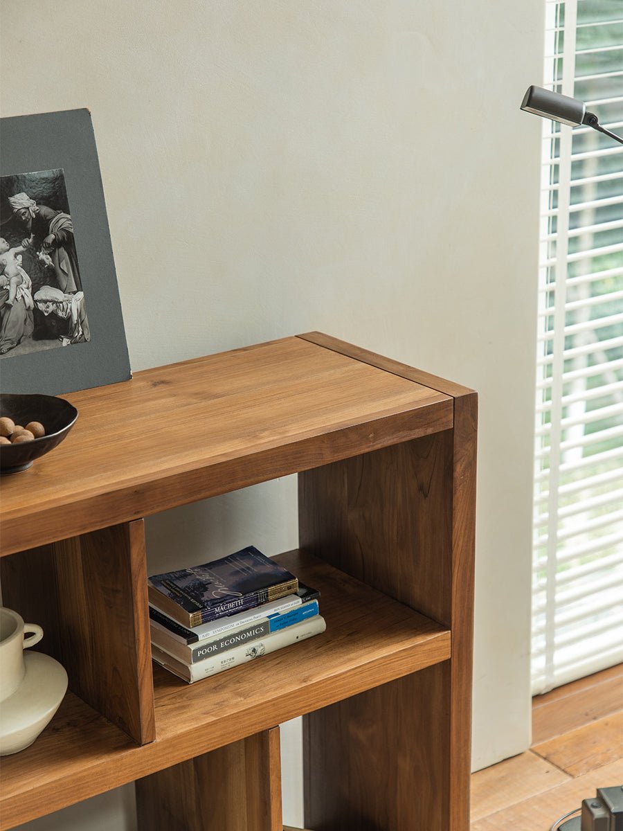 Tome Bookcase, solid wood bookcase with books and decor, cozy interior design. Macbeth and Poor Economics books displayed.