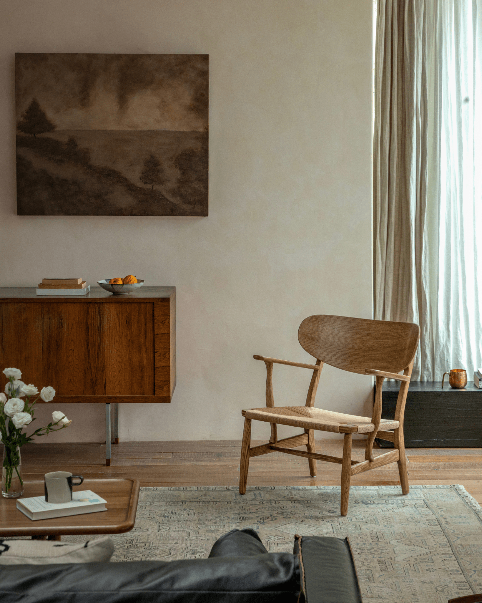 CH22 Lounge Chair, oak frame and woven paper cord seat. Scandinavian design icon for modern interiors.