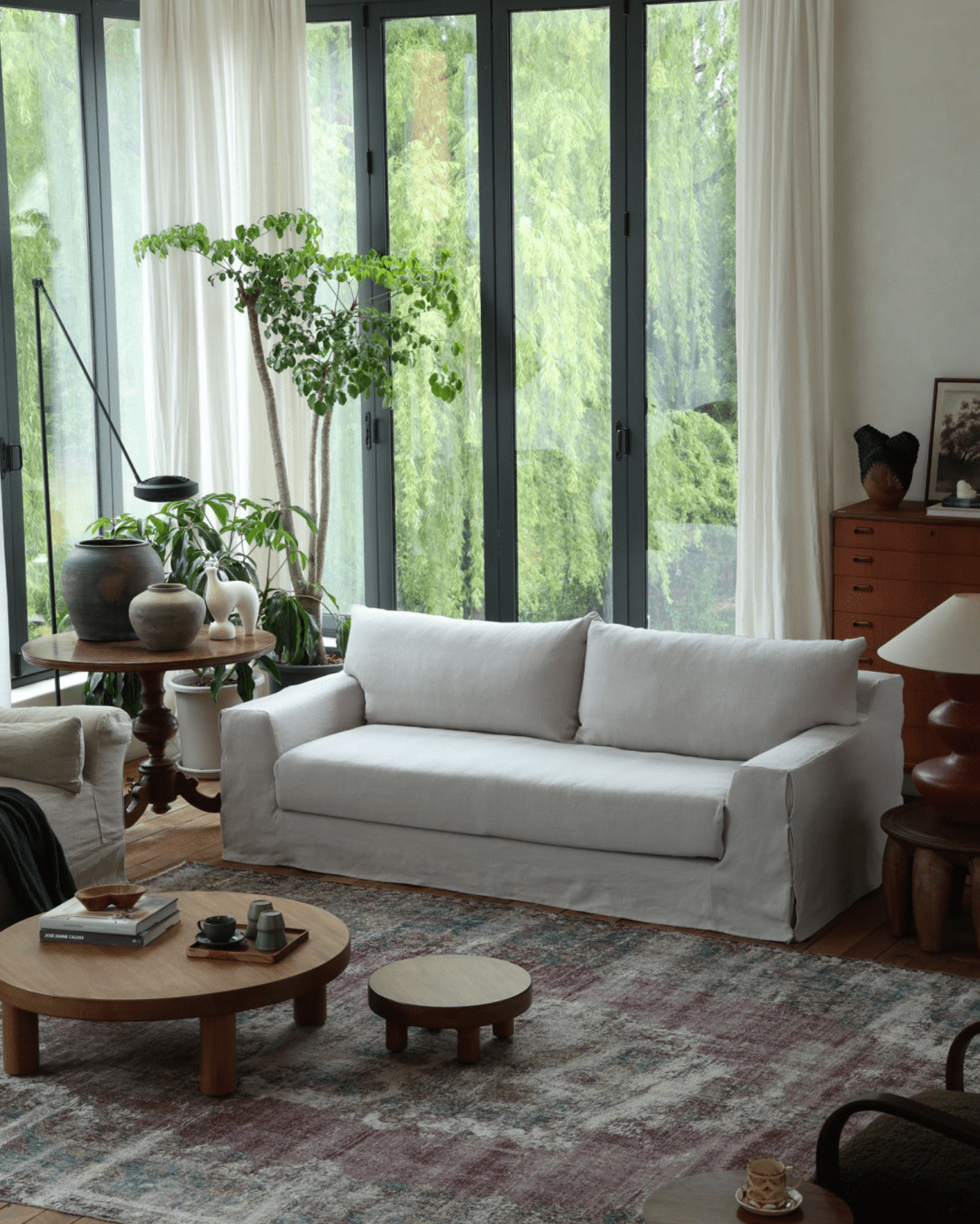 Guni Linen Sofa in a bright living room with neutral linen fabric, offering comfort and style, enhancing natural light.