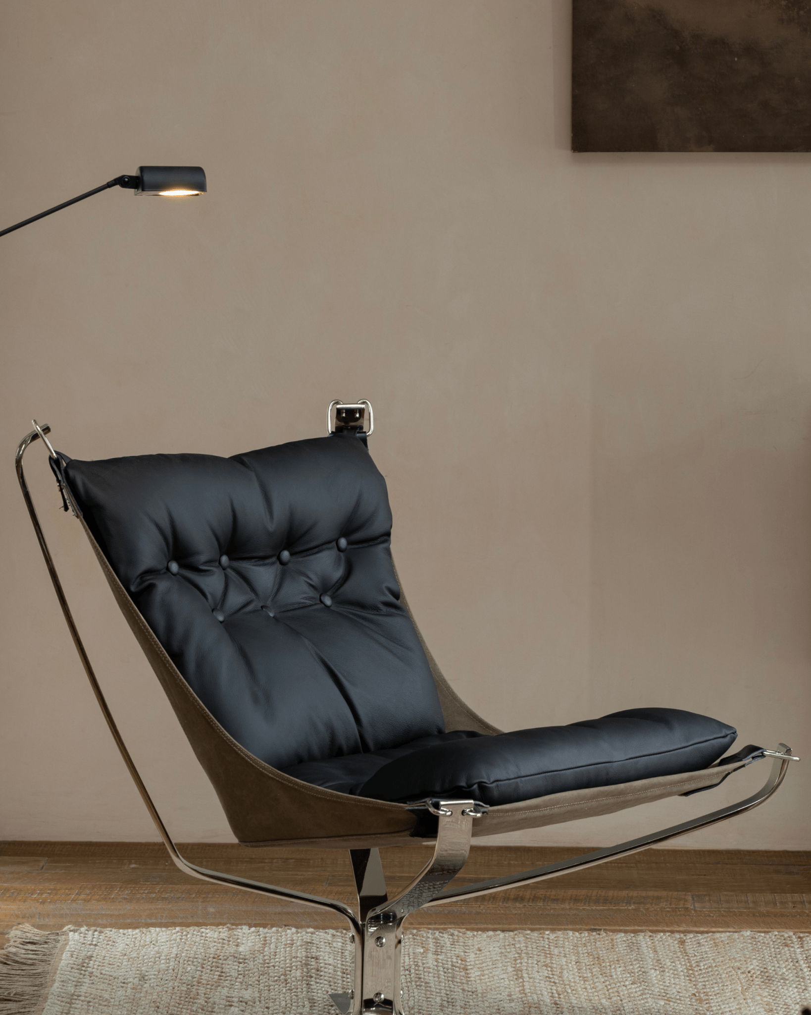 Black leather Falcon Chair with stainless steel frame, modern interior design, Scandinavian comfort