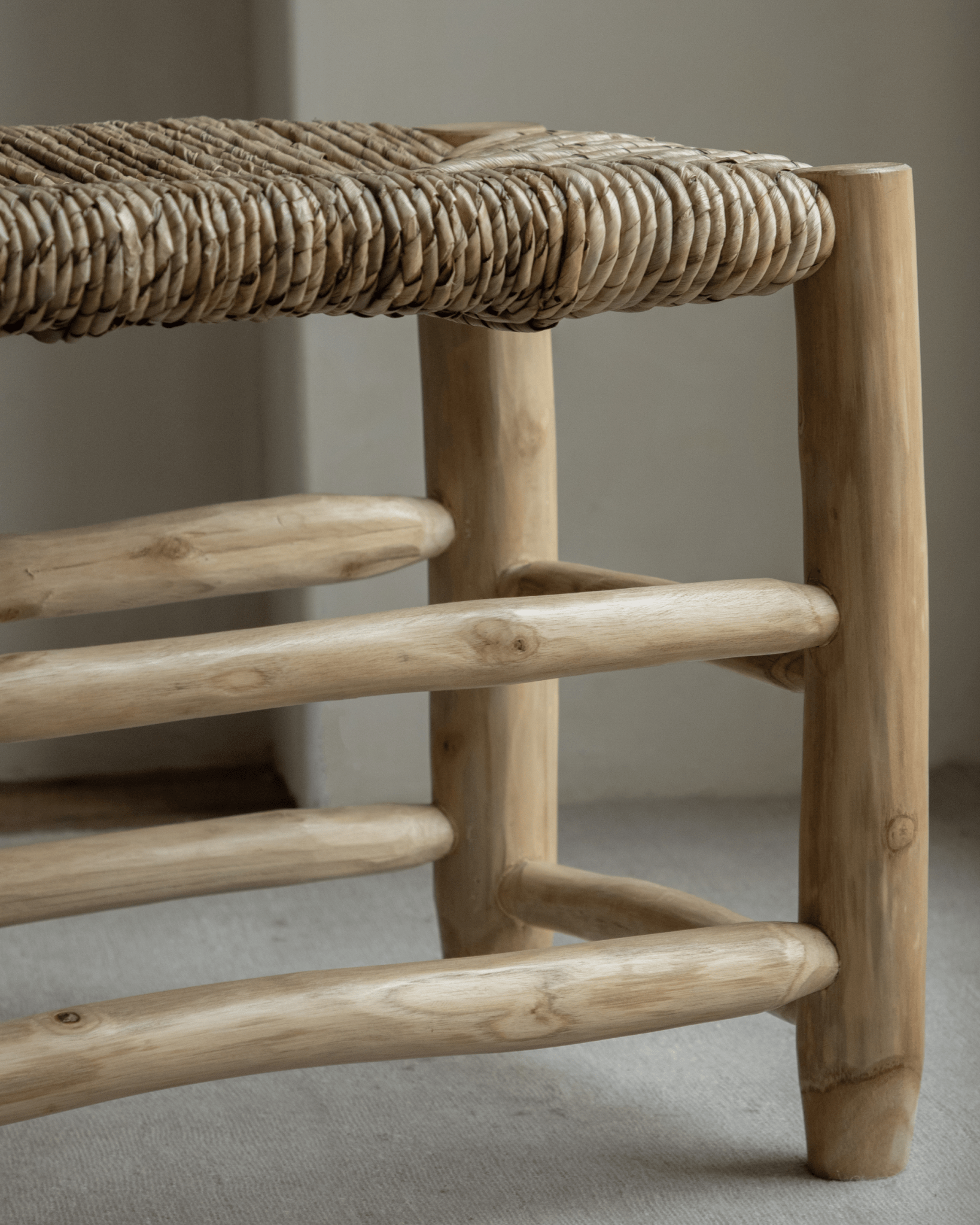 Isla Bench detail: woven pandan leaf seat and solid teak frame, modern organic design