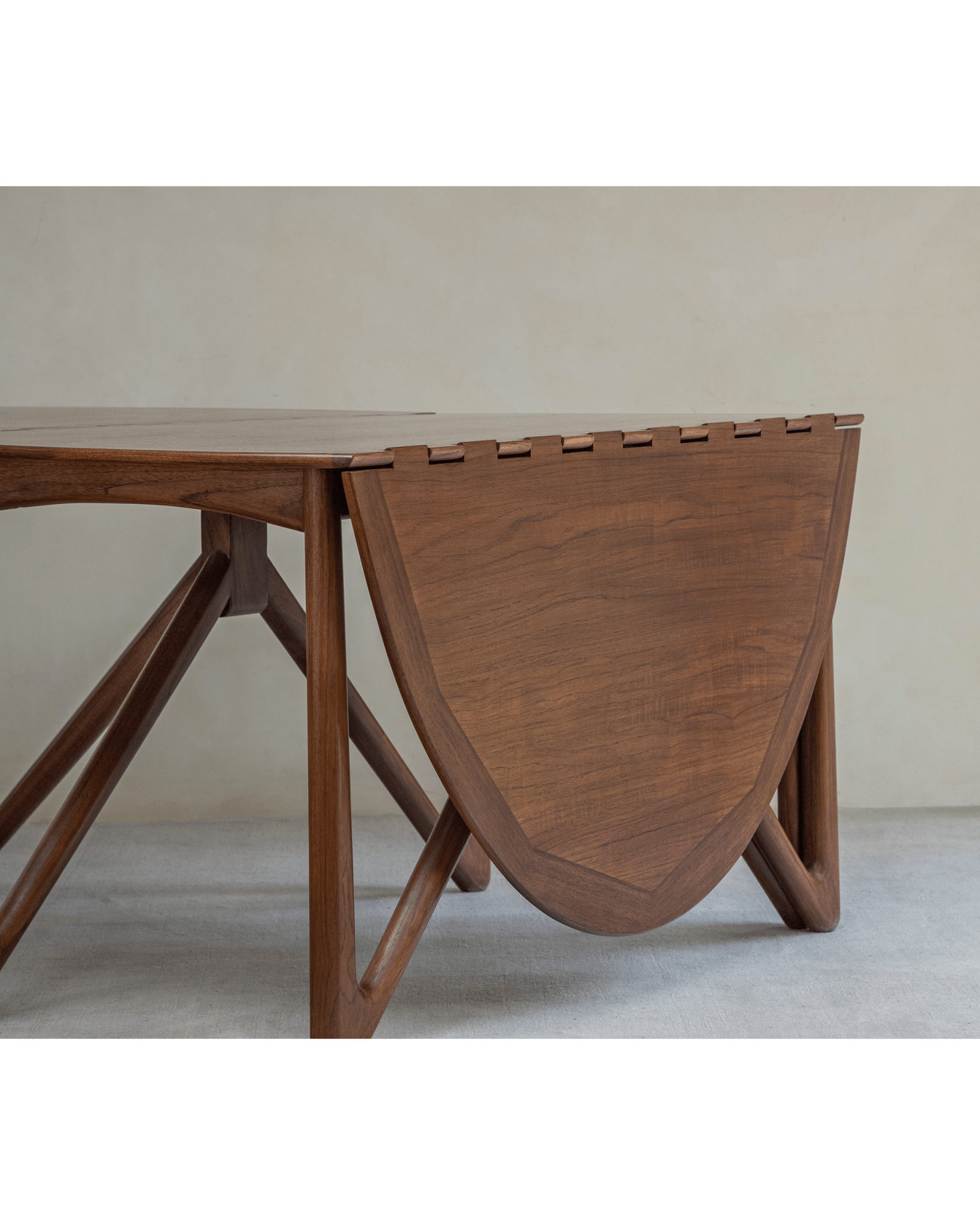 Niels Folding Table, teak wood, partially folded, showing V-shaped legs, mid-century modern design, Burmese teak.