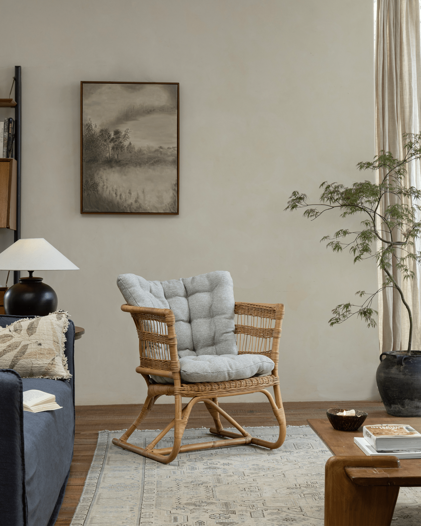 Helian Rattan Chair with gray cushion, natural rattan frame, in cozy interior