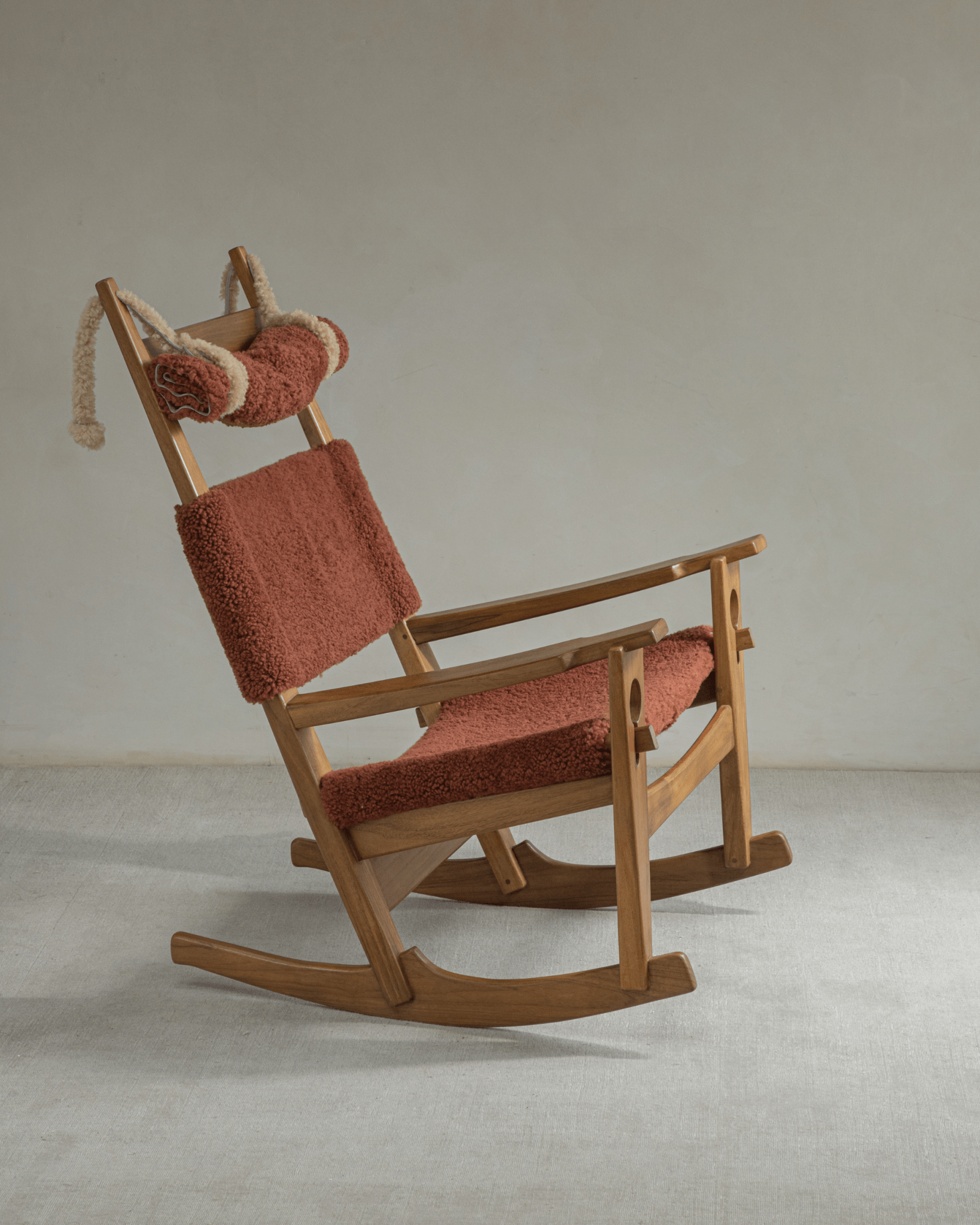 Hans Rocking Chair: Rust shearling upholstery on teak frame, Danish design.