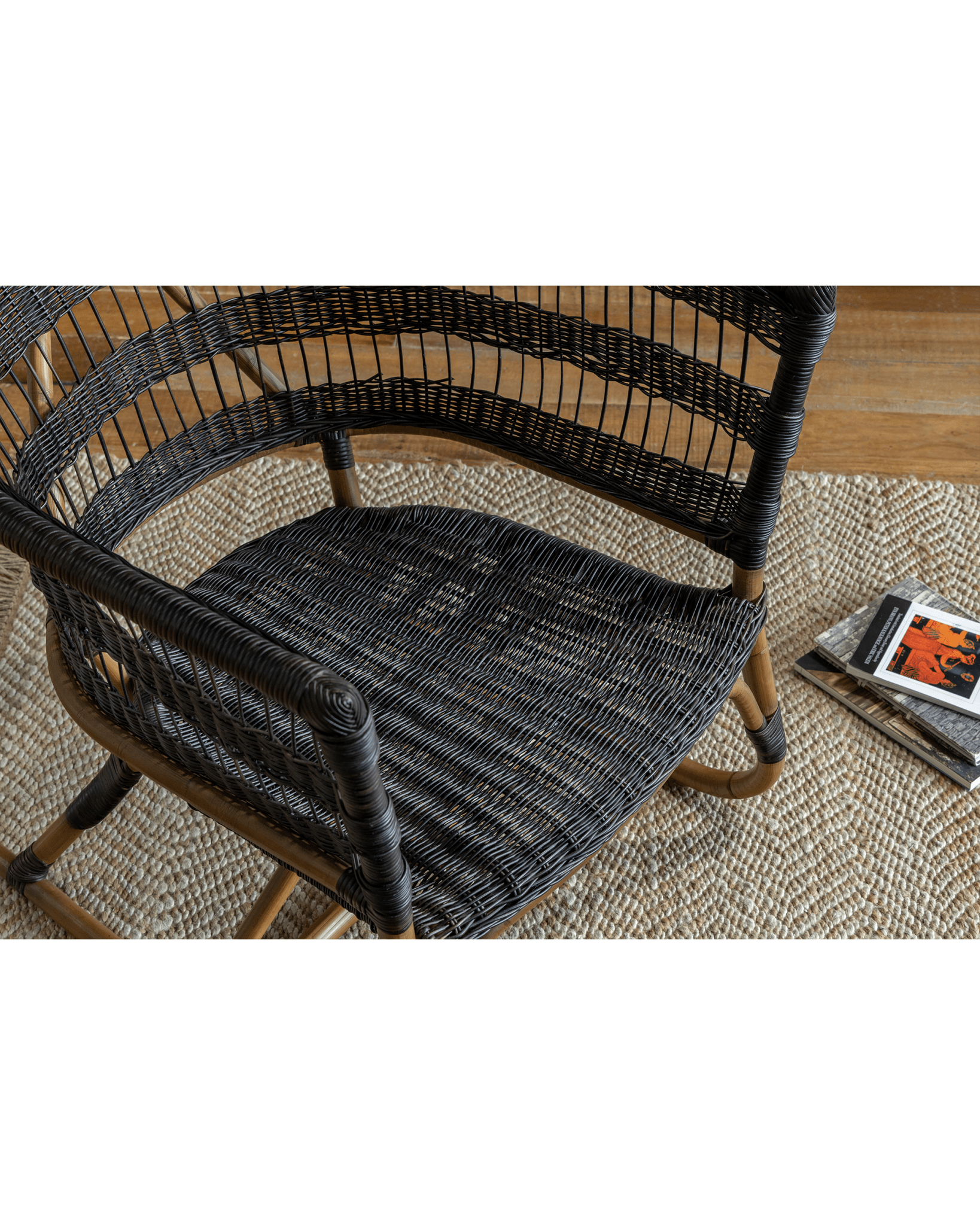 Helian Rattan Chair with black rattan and natural frame, cozy interior setting, modern design.