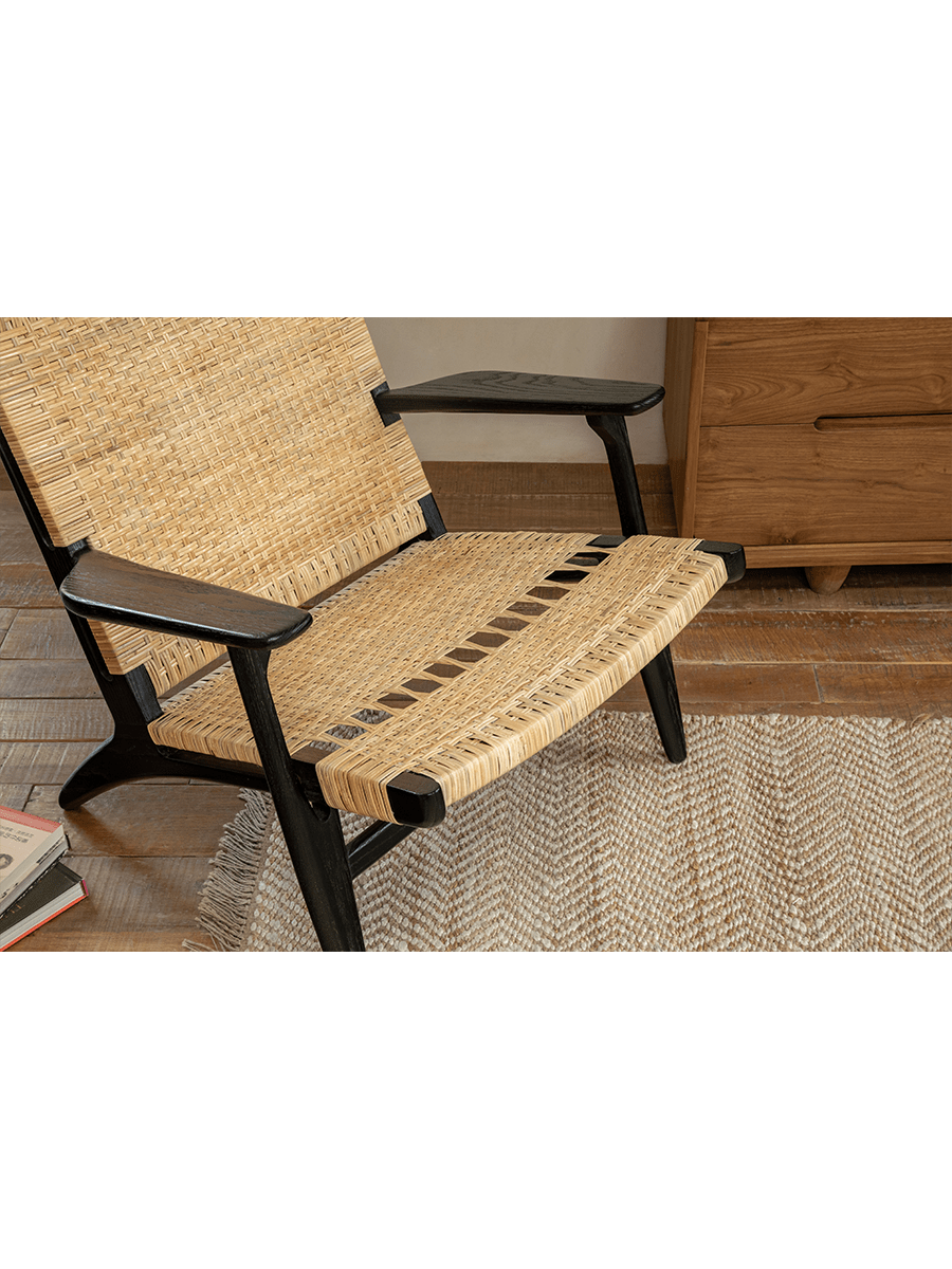 Horn Lounge Chair in black oak and natural rattan, ergonomic design, handcrafted for comfort and interior decor.