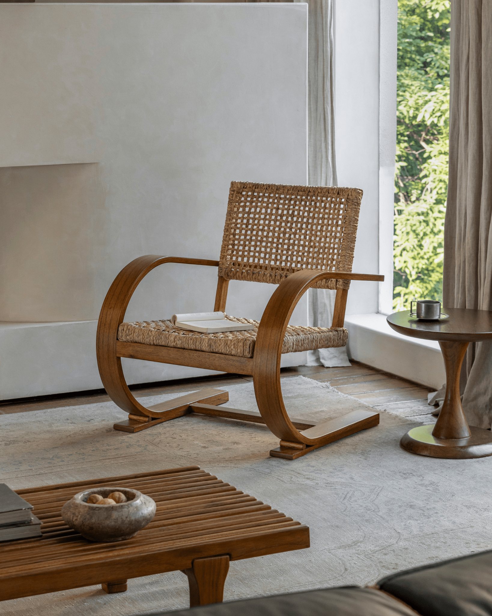 C Curve Lounge Chair in mid-century modern living room setting, with bentwood frame and woven seat, natural light