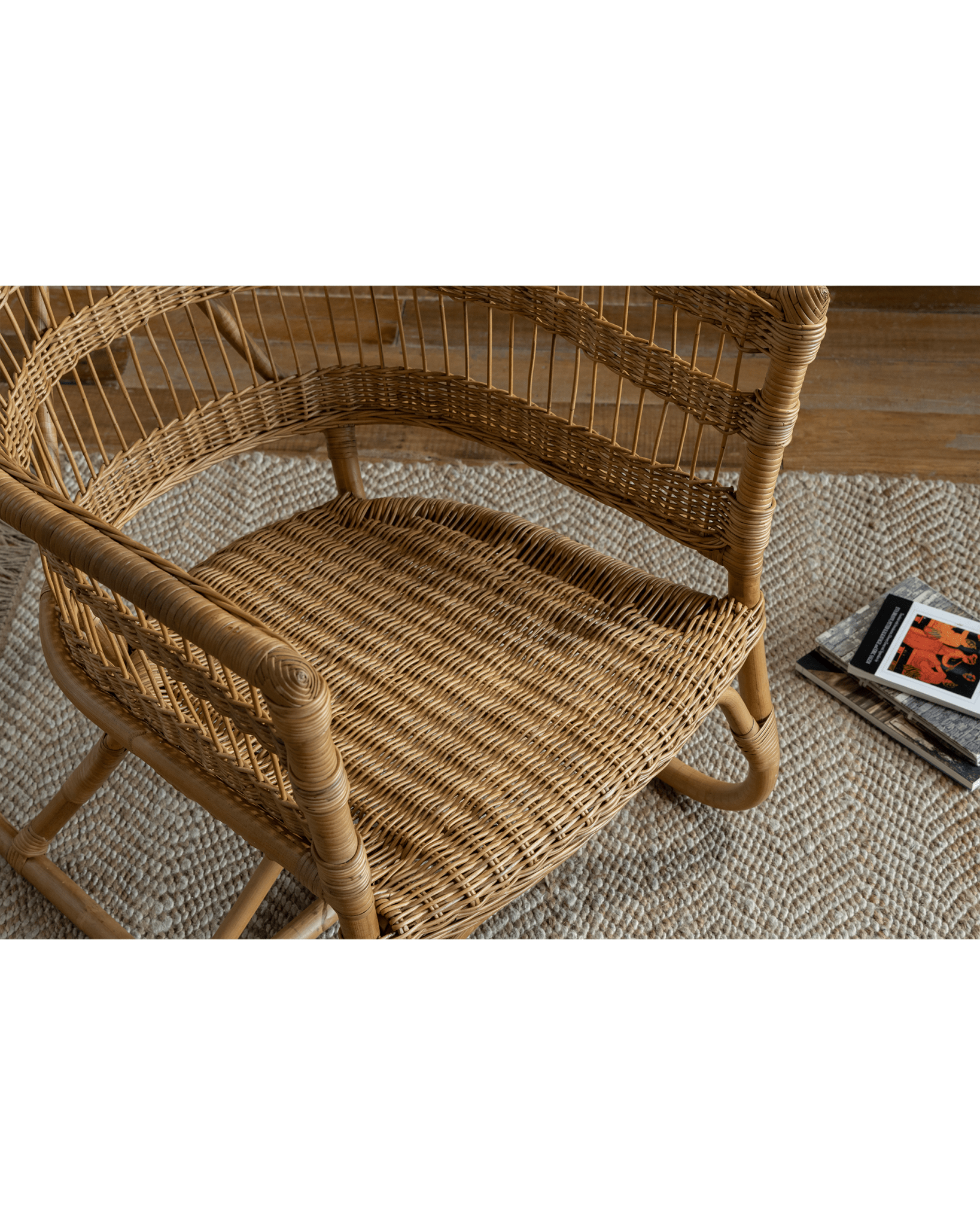 Helian Rattan Chair detail: Natural rattan frame, woven design, cozy interior setting, stylish.