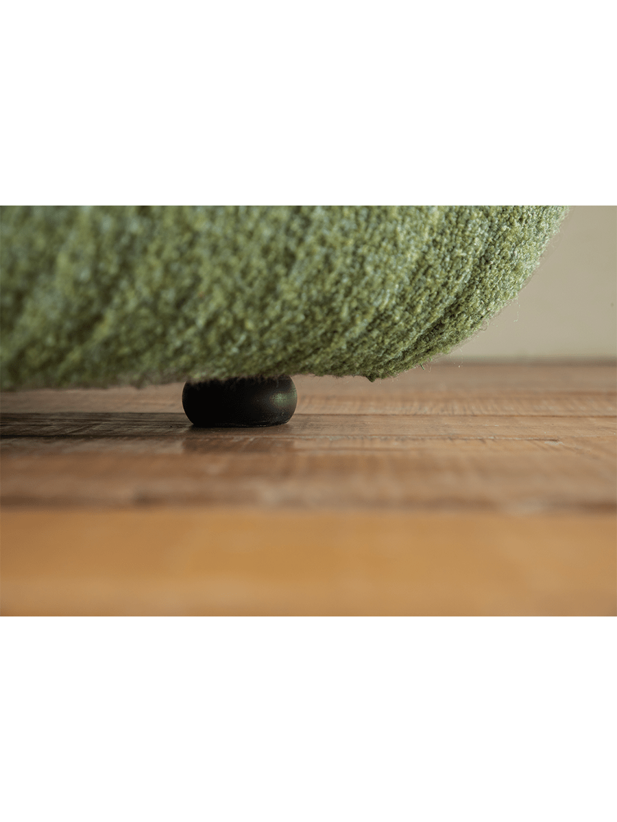 Green Wave Bouclé Sofa detail, showing bouclé fabric texture and wooden leg, perfect for a retro or minimalist interior.