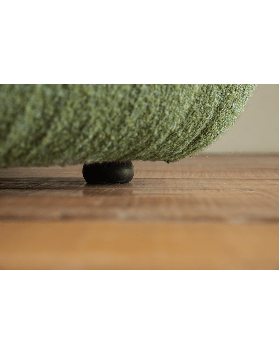 Green Wave Bouclé Sofa detail, showing bouclé fabric texture and wooden leg, perfect for a retro or minimalist interior.