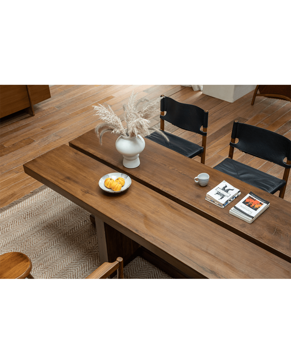 Solid wood sailboat desk in modern interior with elegant decor, natural light, and wooden chairs.