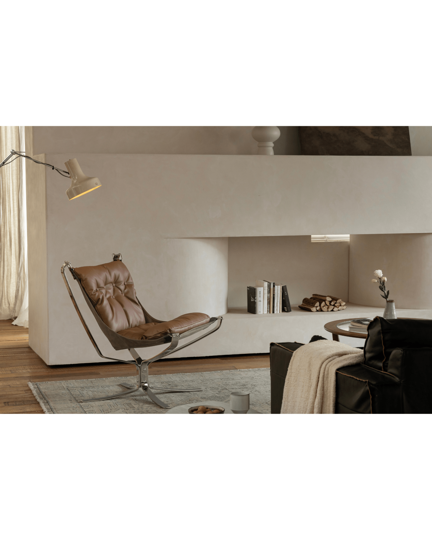 Brown leather Falcon Chair, stainless steel frame, Scandinavian design in modern living room