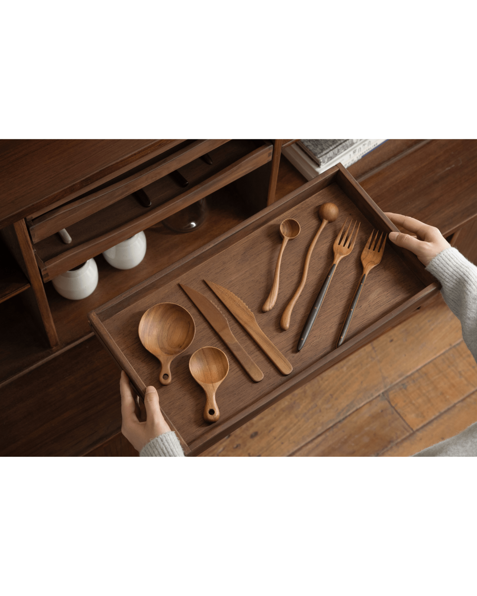 Teak wood utensils on a tray inside the Ibu Teak Sideboard, Scandinavian design