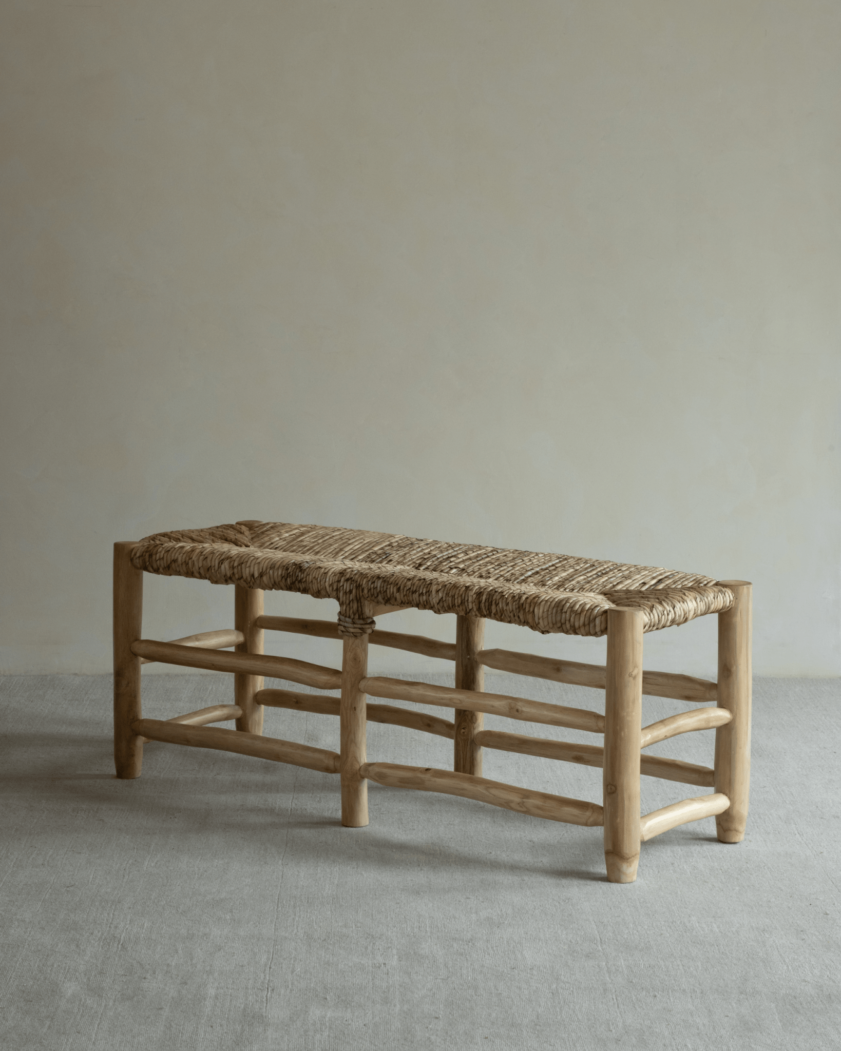 Isla Bench: Modern organic design with woven pandan leaf seat and solid teak wood frame.