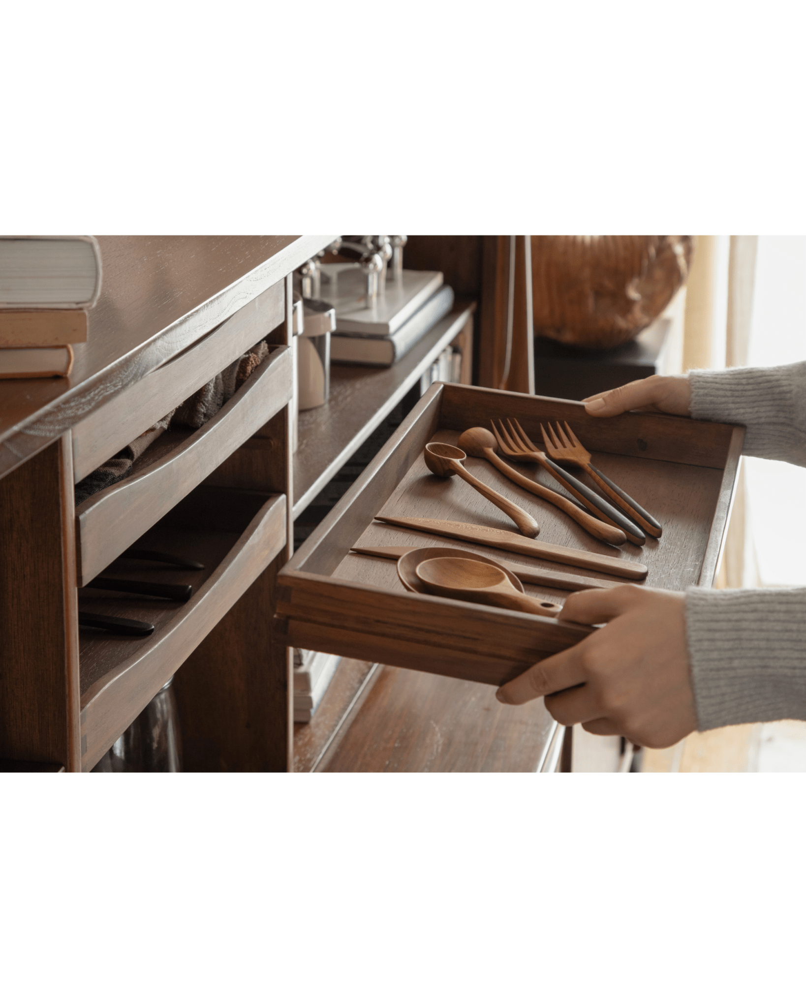 Ibu Teak Sideboard drawer with wooden spoons, forks, and utensils.