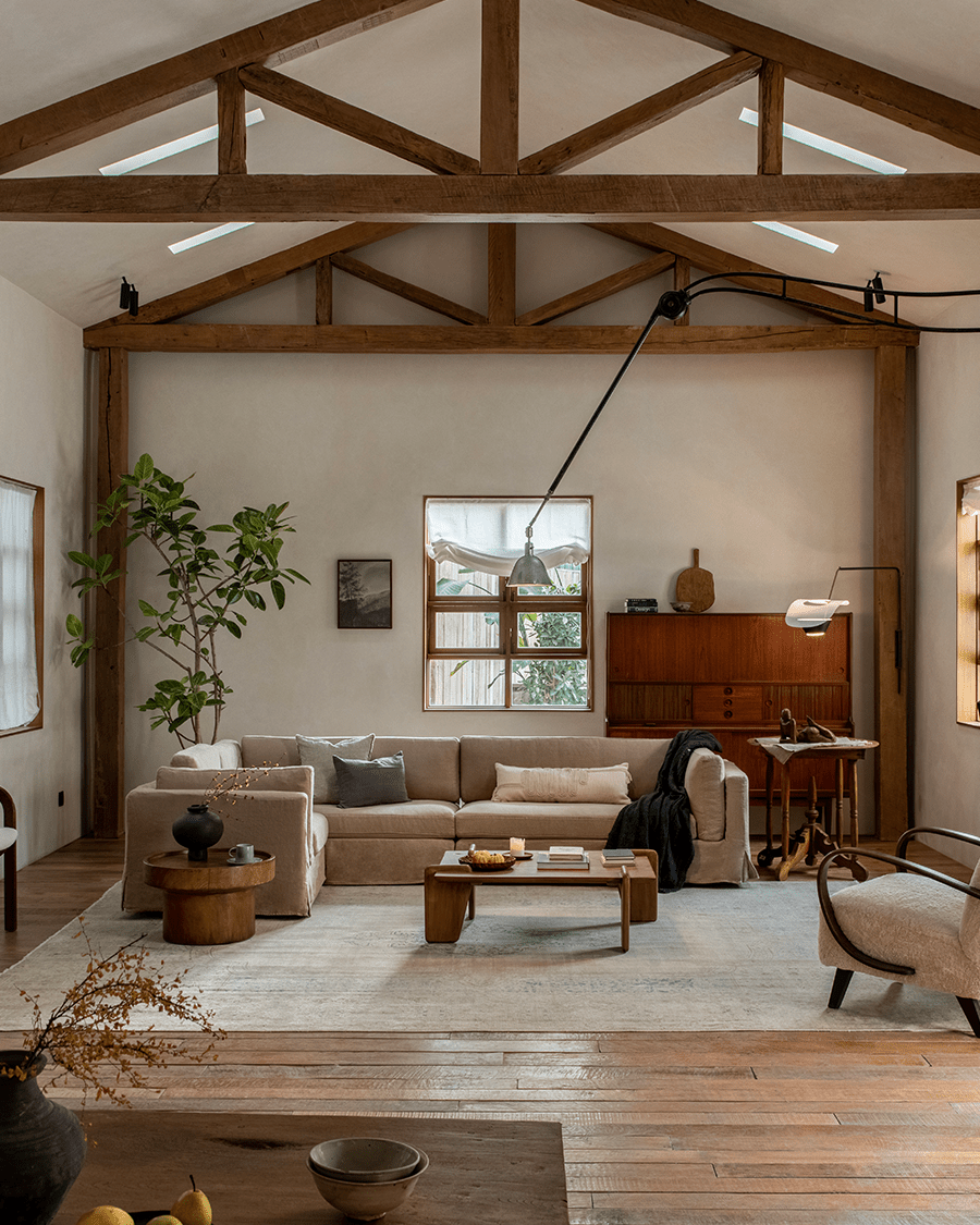 Skirt Sectional Sofa in beige linen, modular design, rustic living room setting.