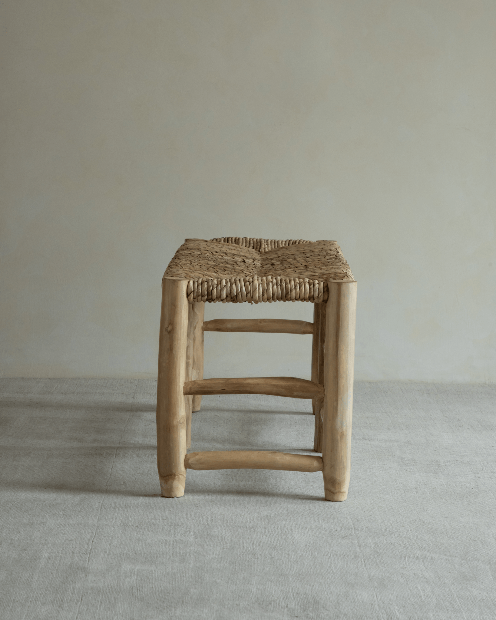 Isla Stool: Woven pandan leaf seat and solid teak frame, modern organic design, natural color.