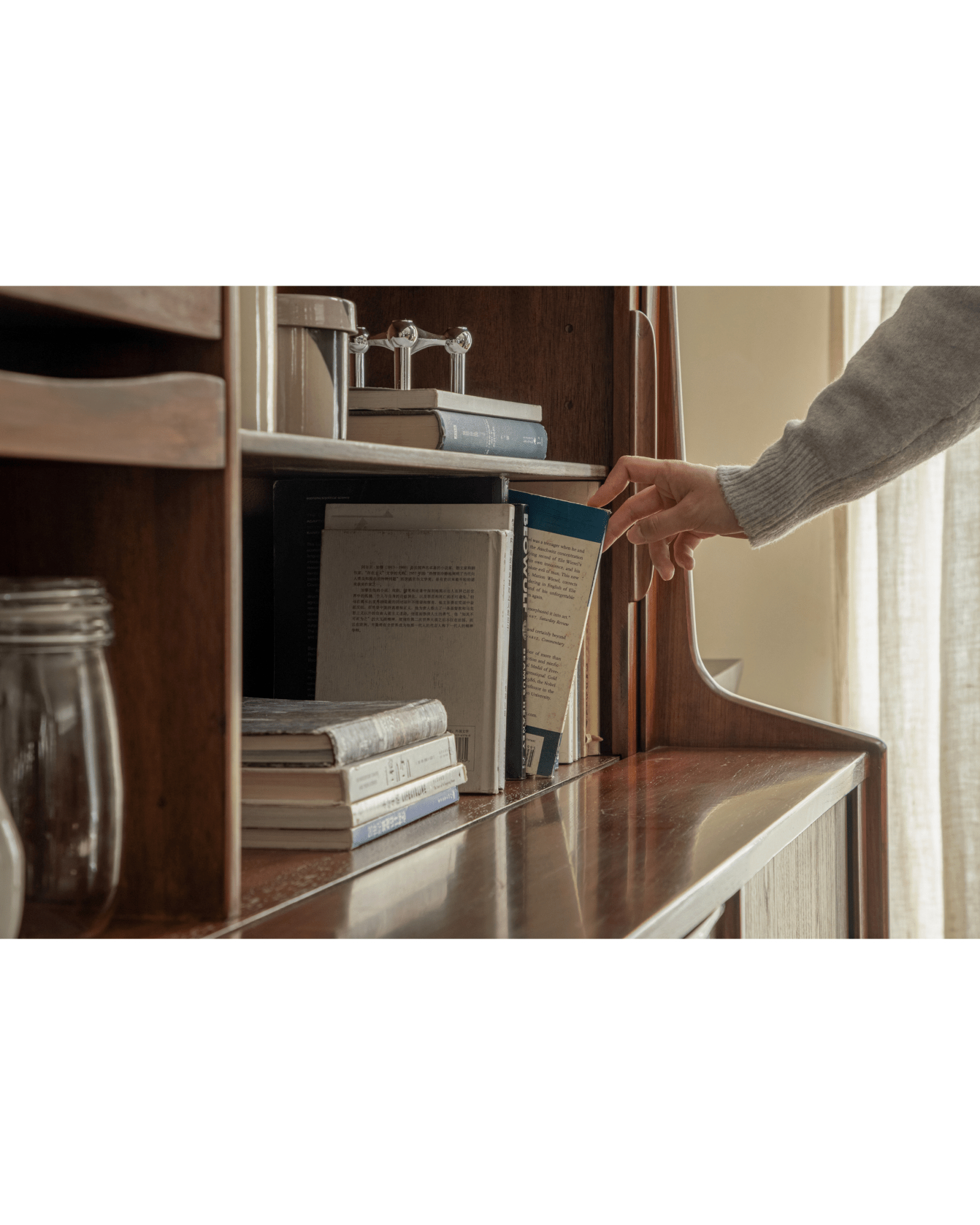 Ibu Teak Sideboard with books on shelves, featuring teak wood and mid-century modern style.