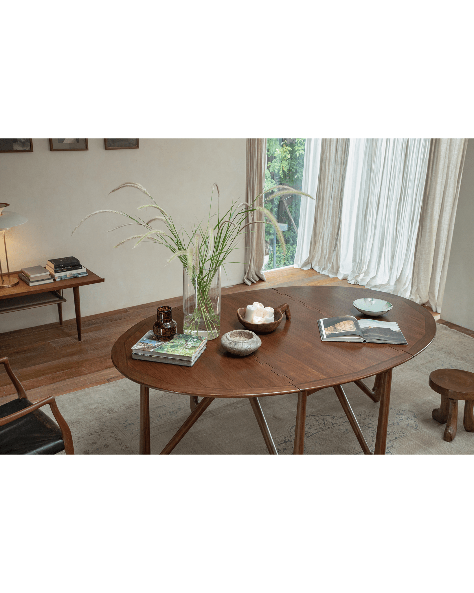 Niels Folding Table extended in teak wood, mid-century modern dining setting, with decor and natural light