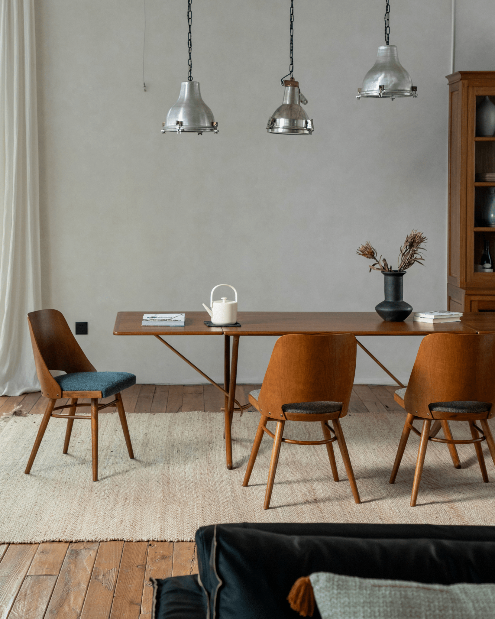 Shell Chair in teak wood dining scene, mid-century modern design, loop fabric seating