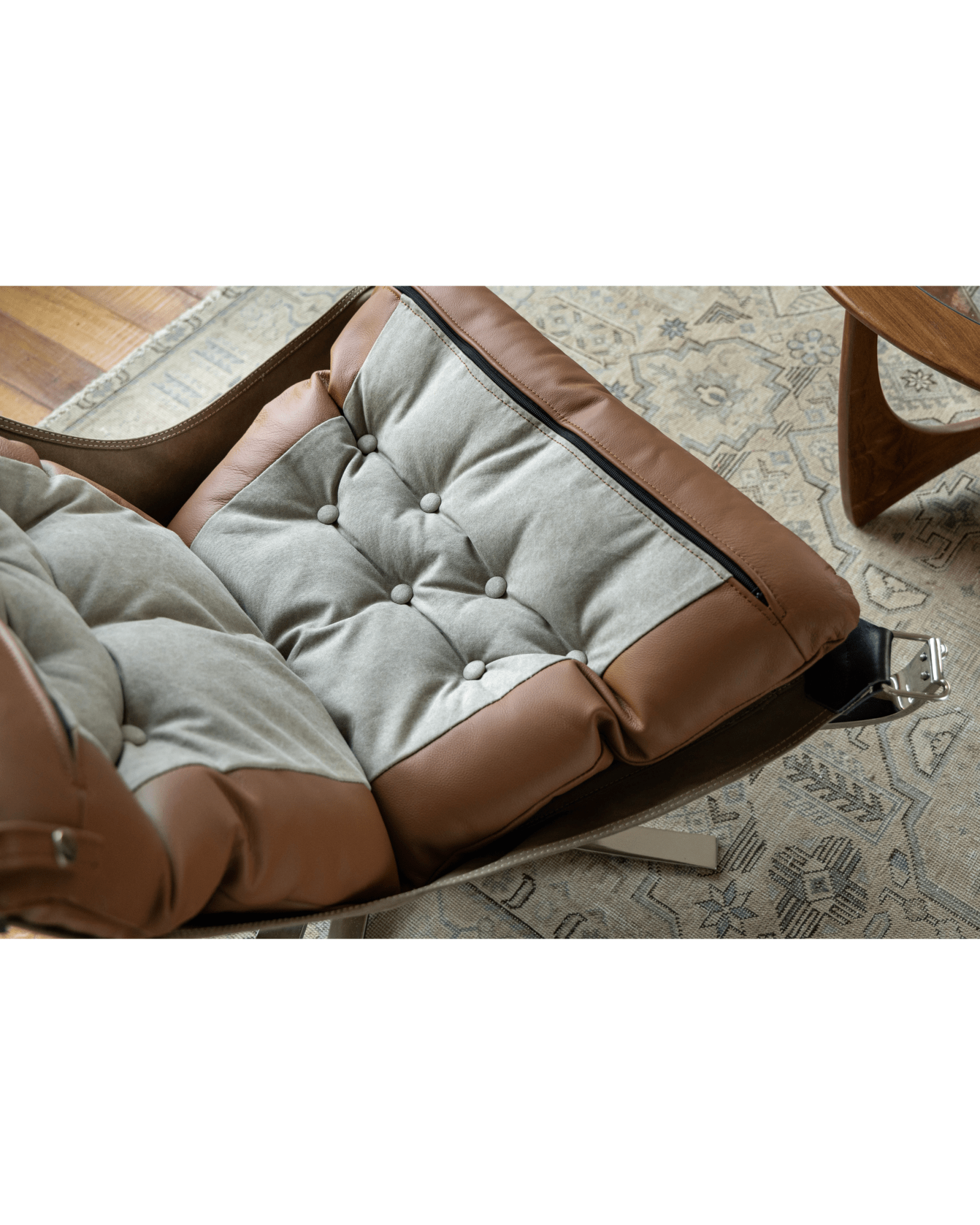 Falcon Chair detail with brown leather and light gray canvas cushion, Scandinavian design