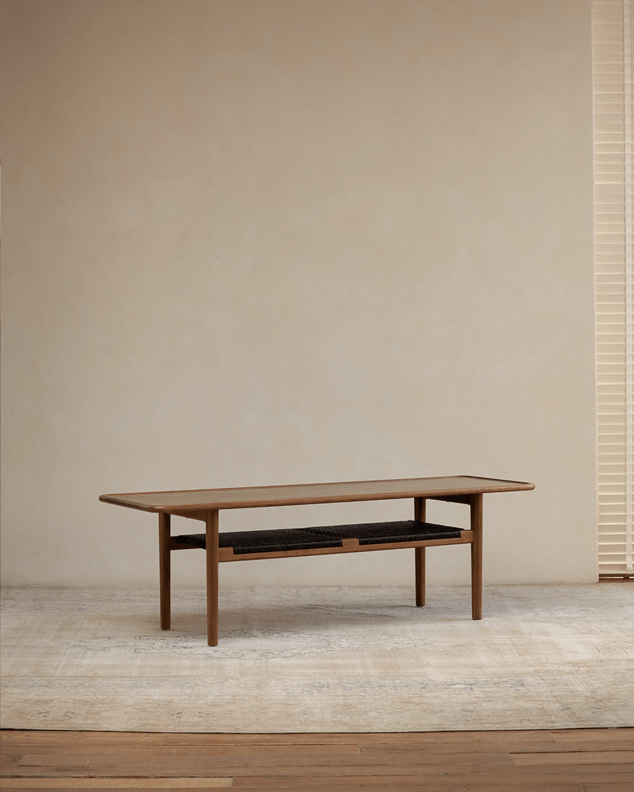 Hans Accent Table - Wooden coffee table with woven shelf, minimalist design.